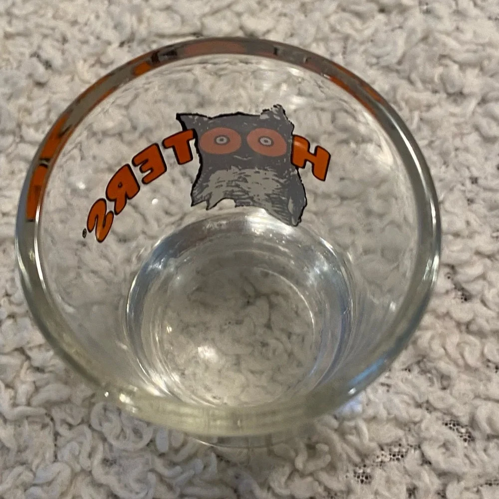 Hooter’s shot glass,  white orange with owl logo, no city specified